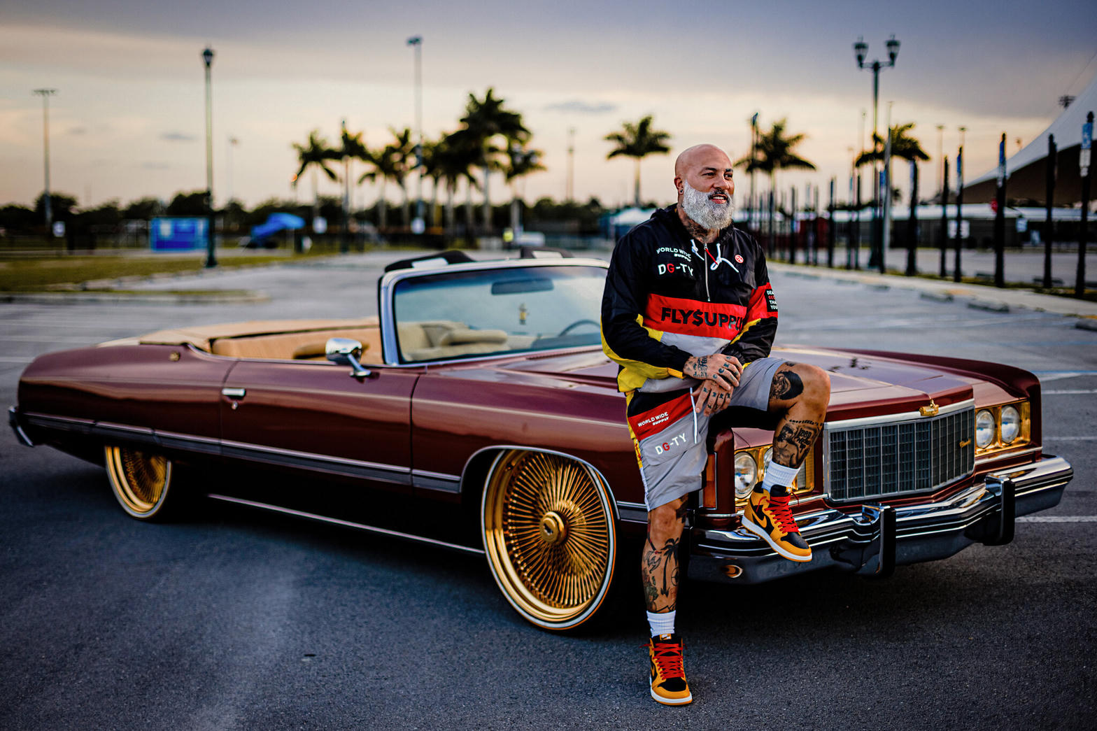 Customized convertible in Miami with gold wheels