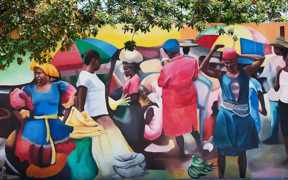 Haitian market mural with figures in colorful clothing
